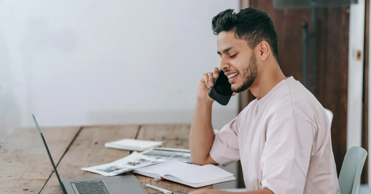 Man Speaking on a Phone at Workplace